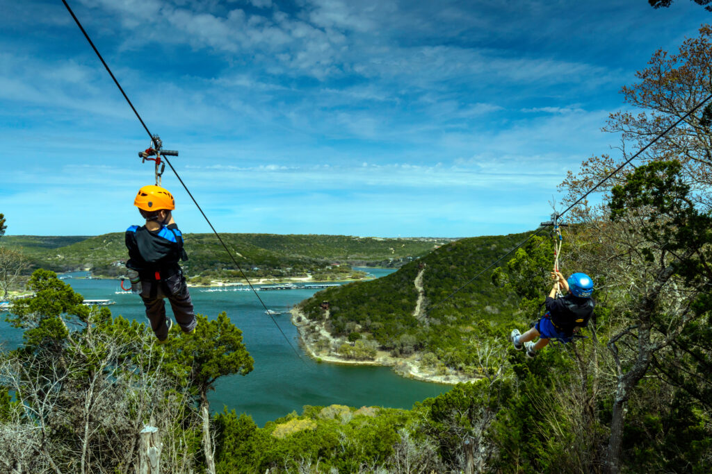 Image courtesy of Lake Travis Zipline Adventures - Two kids ziplining