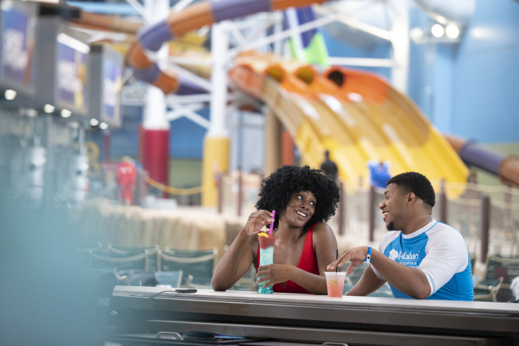 Image of a man and woman at a swim up bar at waterpark