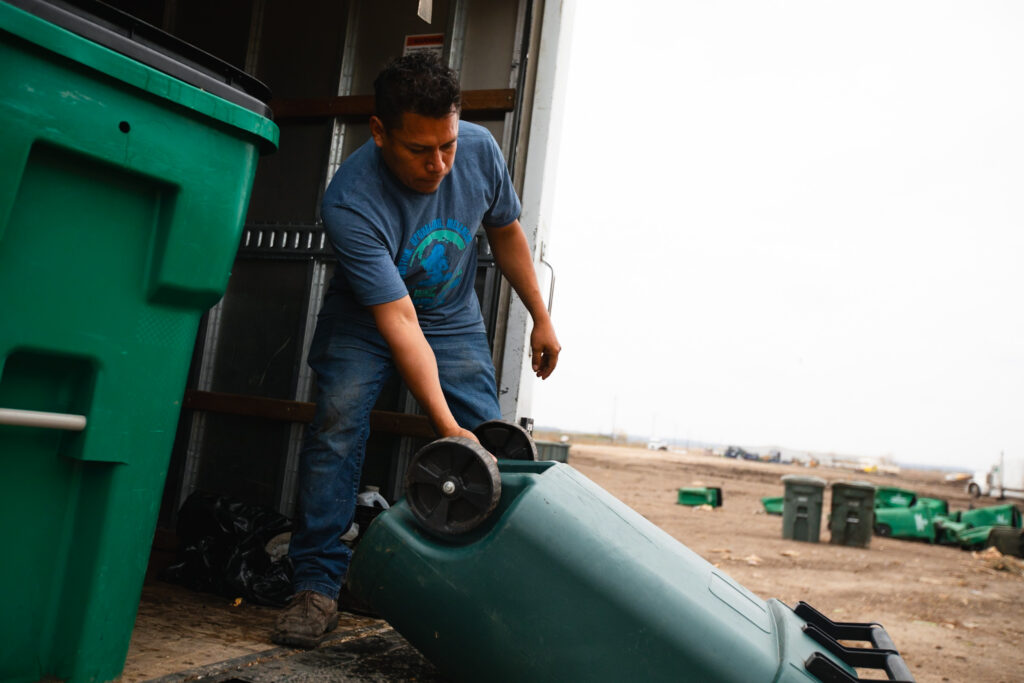 High Vibe Waste team member servicing a residential composting route