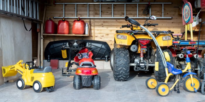 Garage play zone for hot days set up with kids' ride-on toys and open floor space